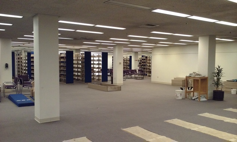 office space showing empty floor with bookshelves removed 