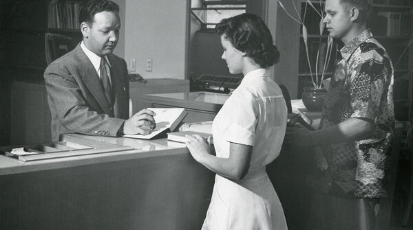 librarian checking out a book 