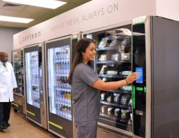 two people in front of a row of vending machines